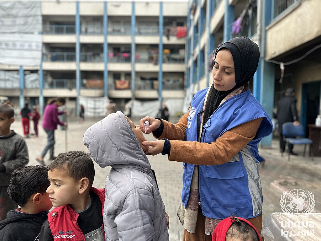 A displaced child receives a polio vaccination in an UNRWA shelter in Beach camp, Gaza Strip